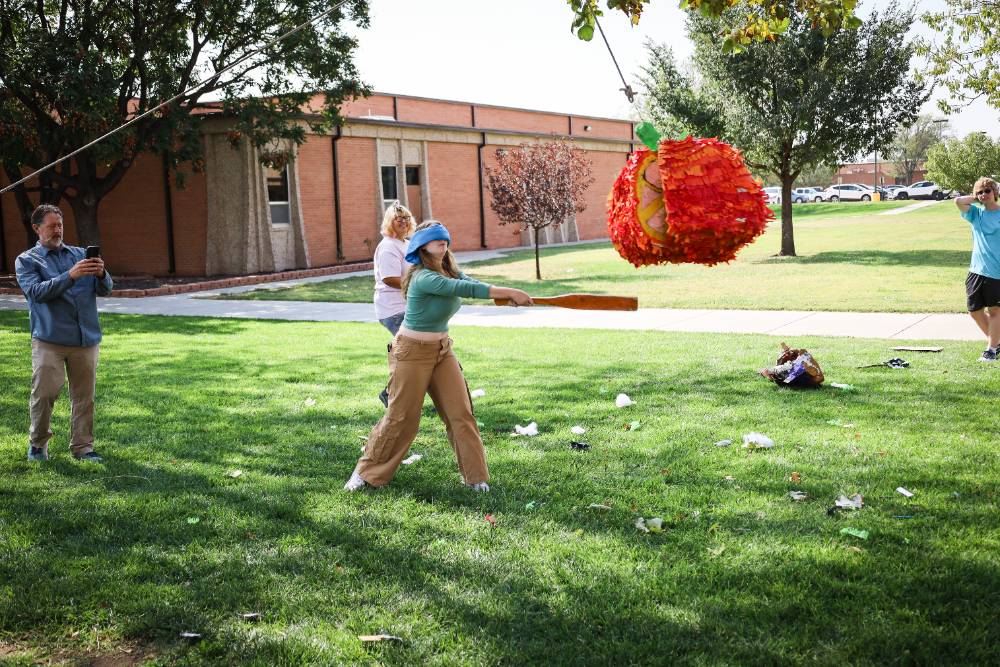 student hitting pinata