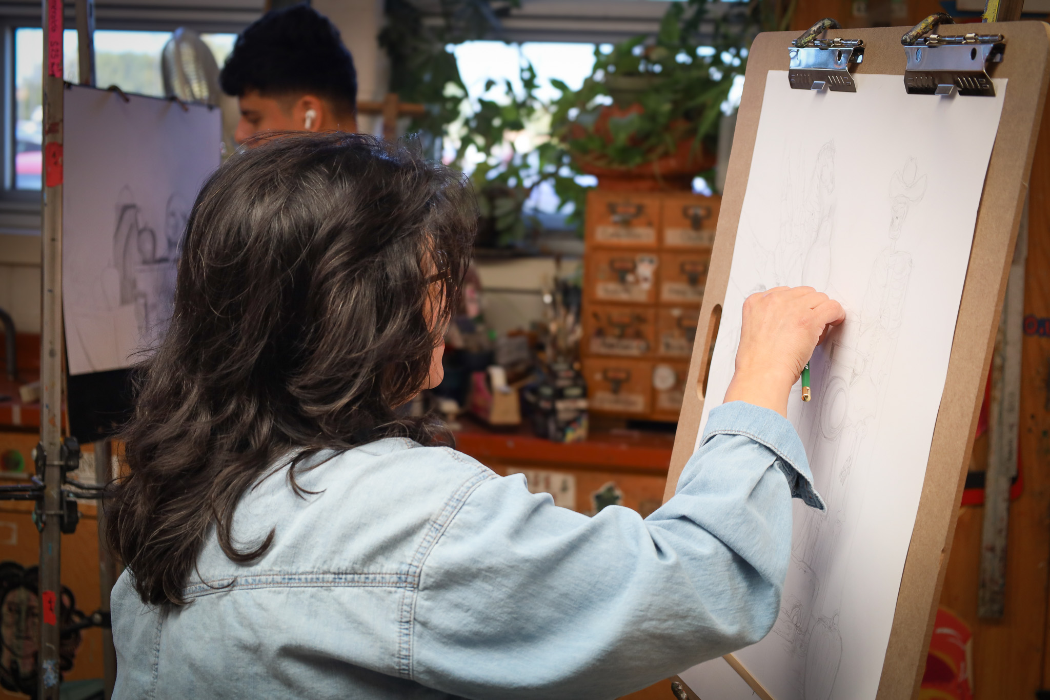 student paining on a canvas.