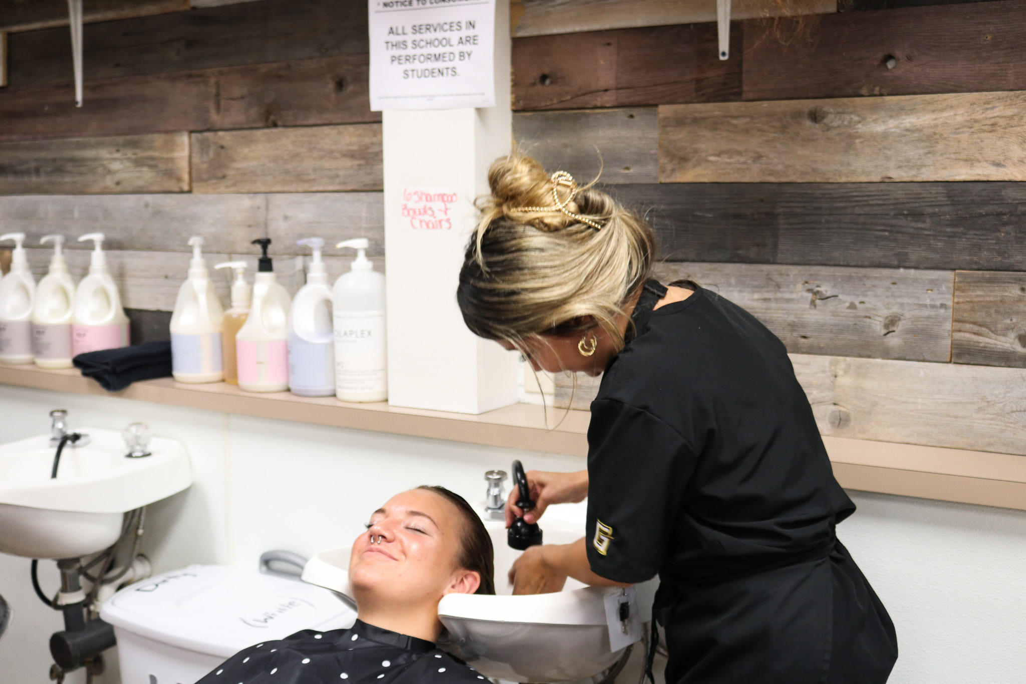 cosmo student washing clients hair.