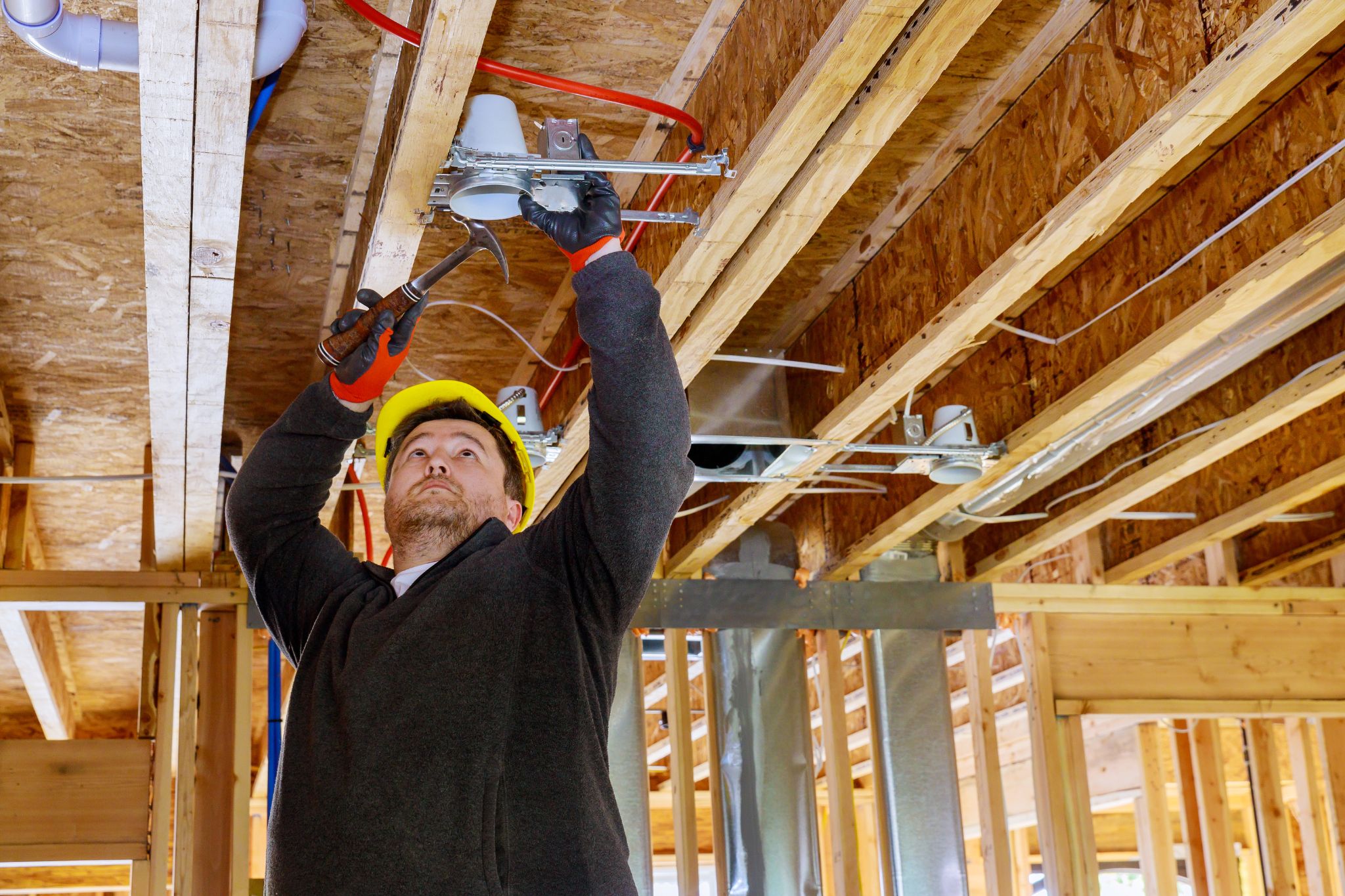 Tradesman working wearing yellow helmet
