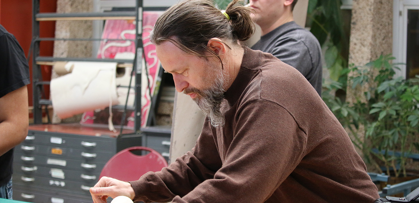 Brian K. McCallum working with clay